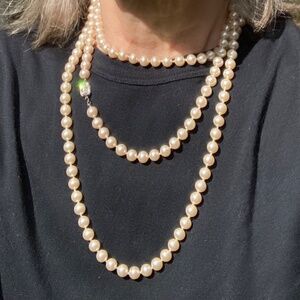 Knotted 60" faux pearl necklace.